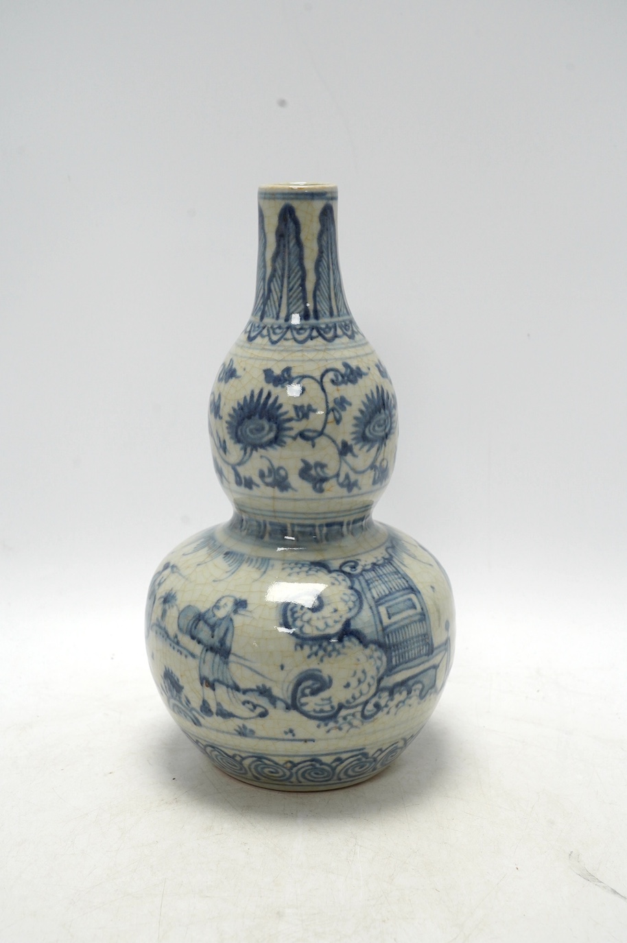 A Chinese blue and white double gourd vase, 28cm high. Condition - fair, chipping to base